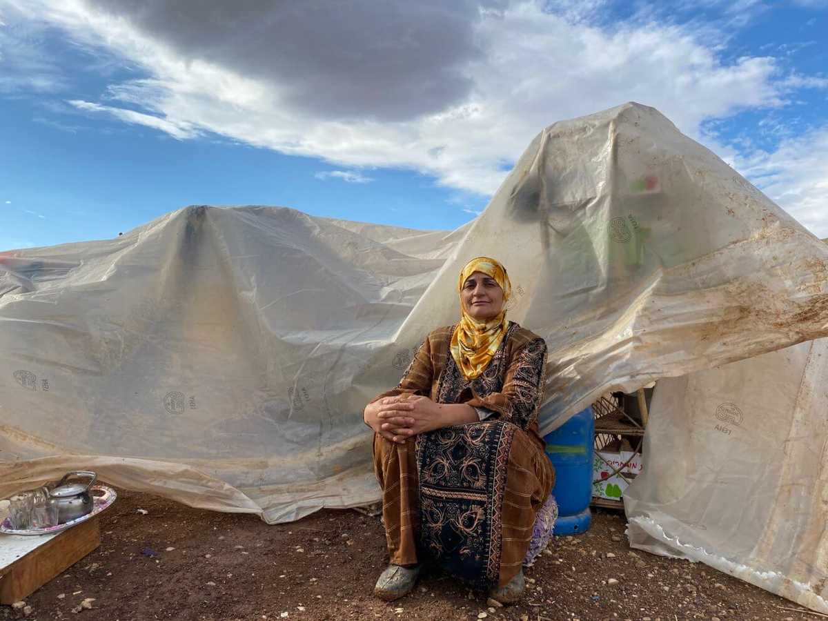 FATIMA ABU AWWAD SITS IN FRONT OF WHAT USED TO BE HER HOME, AFTER ISRAELI FORCES DESTROYED HER VILLAGE OF KHIRBET HUMSAH IN THE JORDAN VALLEY. NOW HER BELONGINGS SIT IN A PILE, COVERED WITH A PLASTIC TARP. 